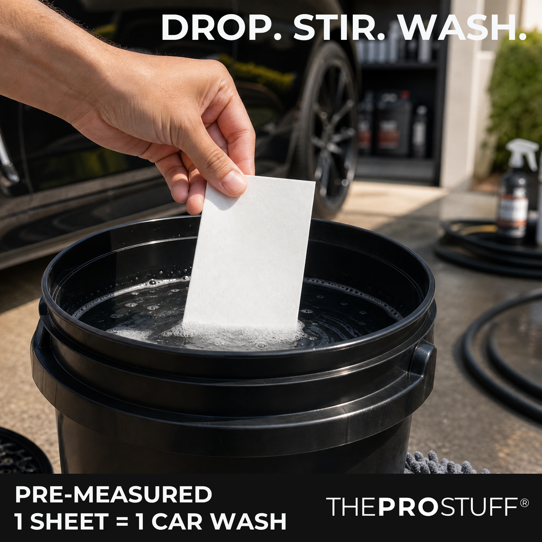 Hand dropping a Car Wash Soap Sheet into a bucket of water, pre-measured for one car wash