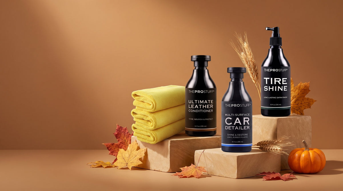 The Pro Stuff Ultimate Leather Conditioner, Multi-Surface Car Detailer, Tire Shine and yellow microfiber towels on stone plinths with autumn leaves