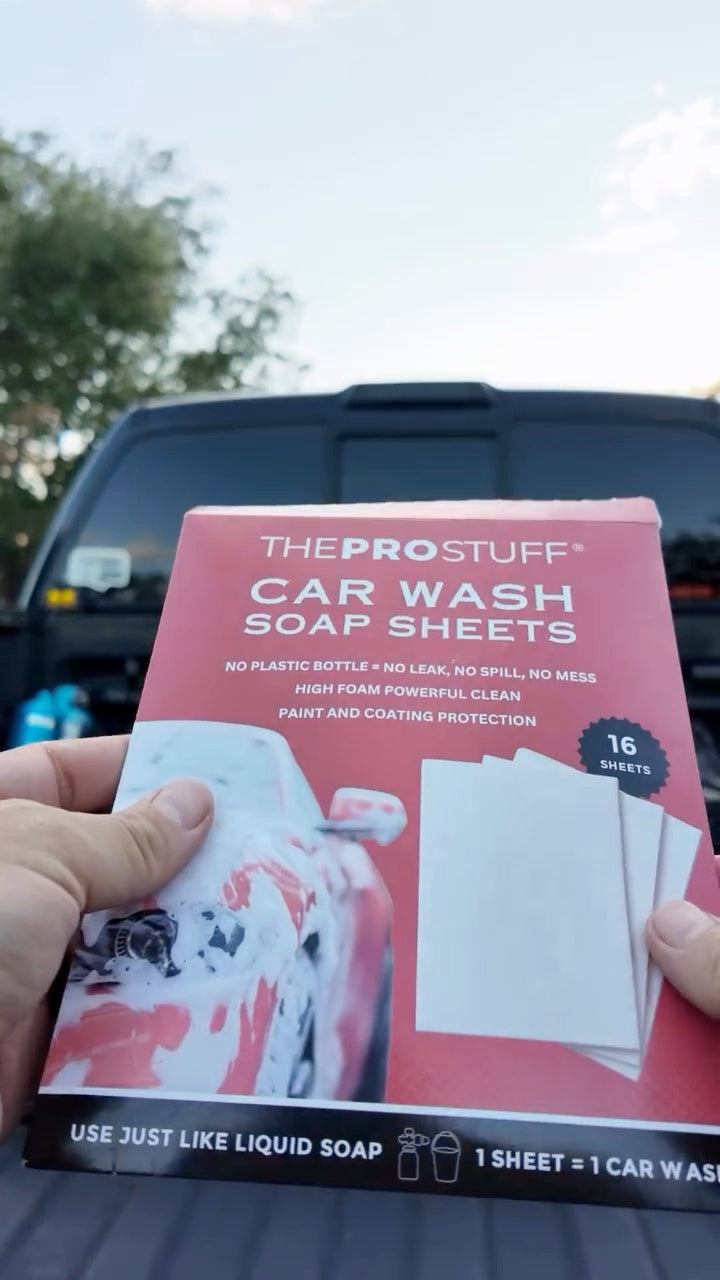 Car Wash Soap Sheets pack held up in front of a Ford Raptor